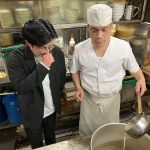 長谷田さんにラーメンの作り方を伝授する榊さん