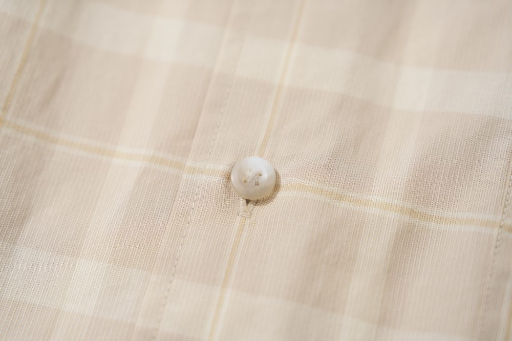 一般的なアメカジシャツはプラスチックの平なボタンが多いが、今作は立体感のある作りで生地に馴染むように同じトーンで構成
